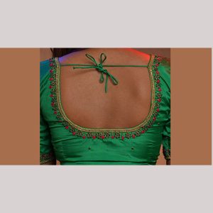 Emerald green blouse with contrast red thread embroidery